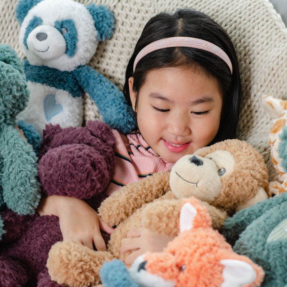 Young Girl Holding Zoologee Stuffed Animals